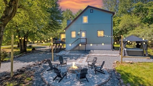 A house with a fire pit, outdoor seating, and a hot tub. - New! Hot Tub, Fire-pit, Shuffleboard, Games Room, Kids Area in Gated Community (Albrightsville)