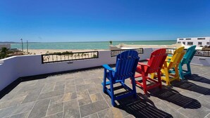 A terrace with chairs and a view of the sea. - Seaside Hacienda, Laguna Shores Resort, 6 Bedroom (Puerto Peñasco)