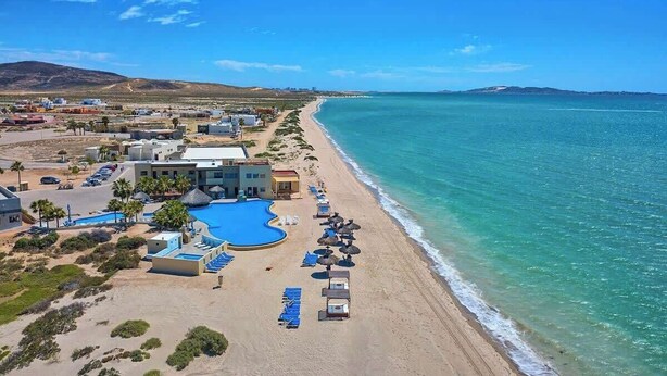 An aerial view of a coastal resort with a swimming pool, beach, and ocean. - Seaside Hacienda, Laguna Shores Resort, 6 Bedroom (Puerto Peñasco)