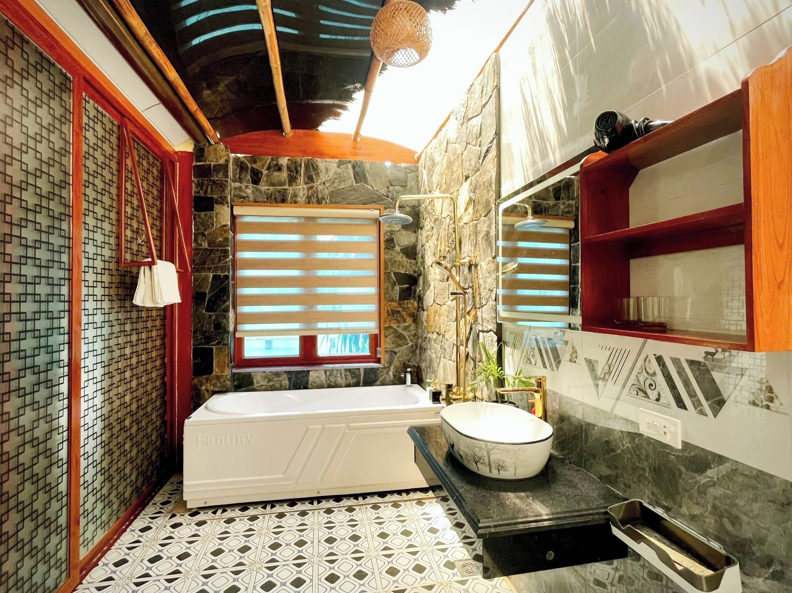 A bathroom with a bathtub, a sink, and a window with blinds.