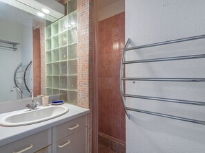 Bathroom features a sink, mirror, and towel rack.