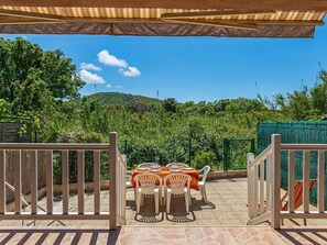 Enjoy a romantic meal in this outdoor setting with a lush view.