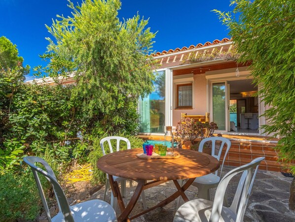 Relax on the patio surrounded by lush greenery and enjoy the tranquil atmosphere.