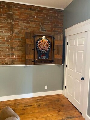Relax in a cozy space with a dartboard and a convenient door.