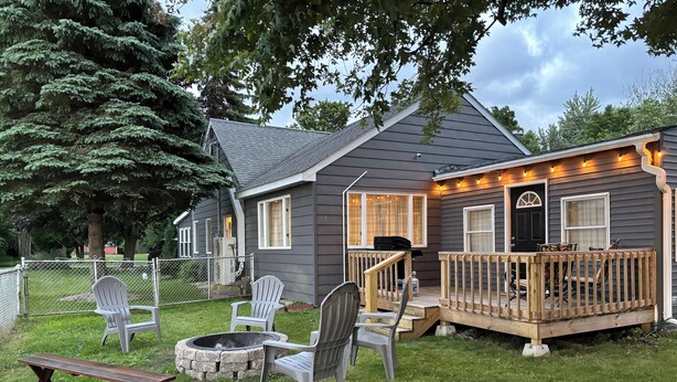 A house with a deck, outdoor seating, and a fire pit. - Stay Now on the GOTL Strip! Across from Eddie's Grill, Steps from Multiple Bars (Geneva)