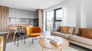 En moderne lejlighed med spiseplads, sofa og sofabord.