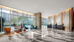 A spacious lobby with a check-in counter, seating area, and large windows offering views of the city. - Fraser Place Chengdu  (Chengdu)
