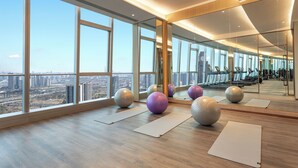 A spacious gym with large windows, exercise balls, and mirrors. - Fraser Place Chengdu  (Chengdu)