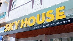 Un letrero que dice "SKYHOUSE" con la dirección "65 NGYEN THI NGHIA, TP. DALAT".