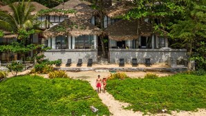 A resort with thatched-roof villas, a pool, and a sandy beach area. - Sealord Naithon Beach Phuket (Sa Khu)