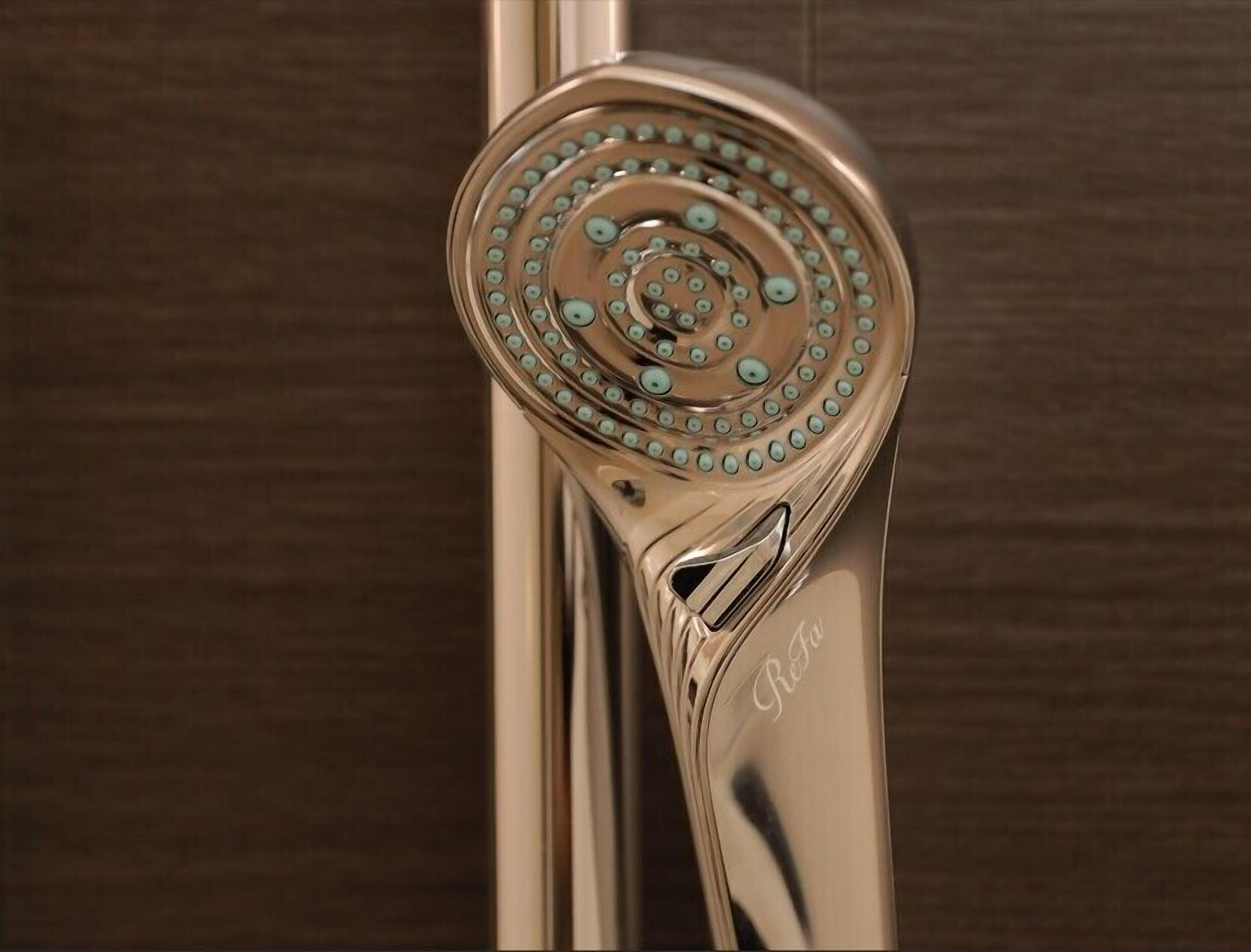 A showerhead with a circular design and a metallic finish.