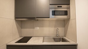 A modern kitchen with stainless steel appliances, a built-in oven, and a sink with a faucet. - Domus in Lauro (Coronari) (Roma)