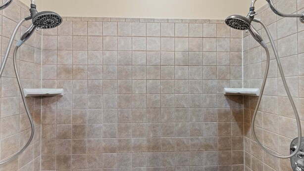 A shower with a tiled wall and two showerheads. - Stoneledge Manor (Banner Elk)