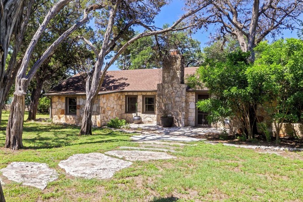 Nestled above the serene limestone shores of Lake Travis, this retreat offers over 300 feet of private lake shoreline and endless panoramic views