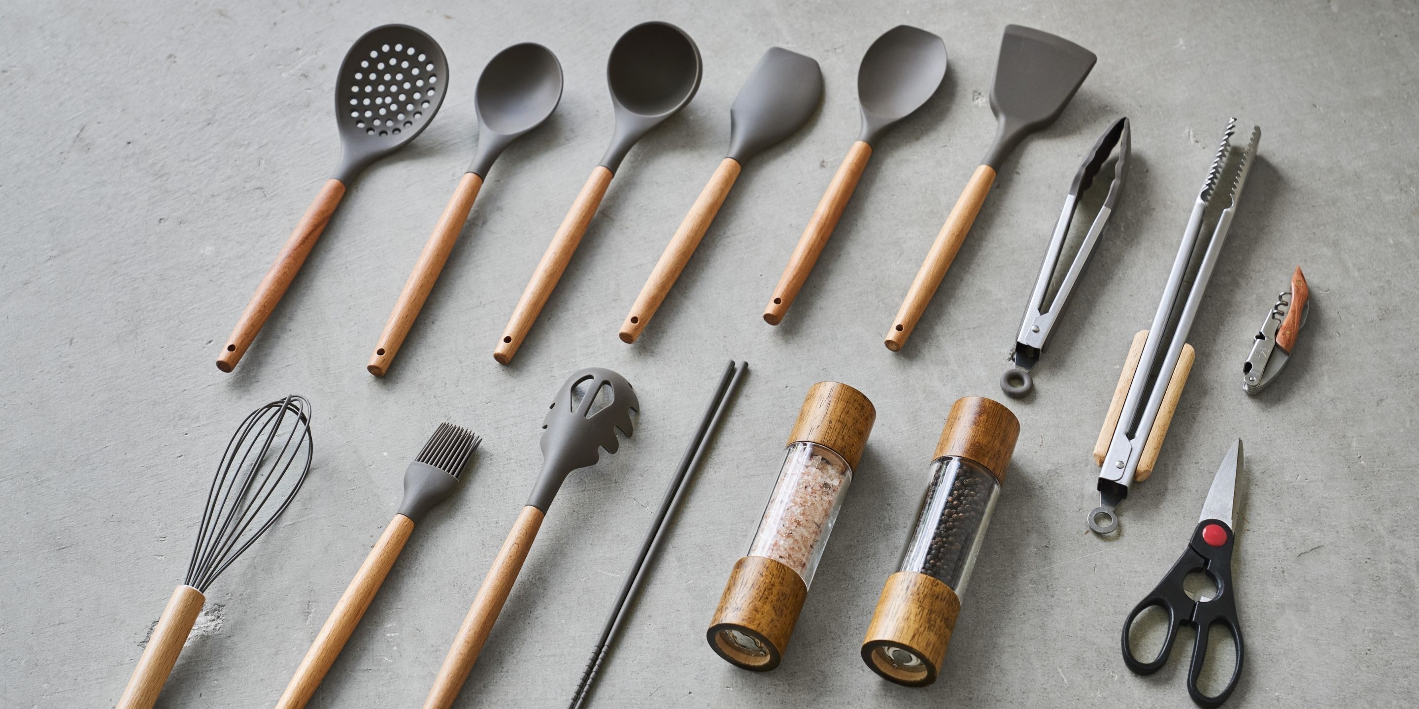 Various kitchen utensils laid out on a surface.