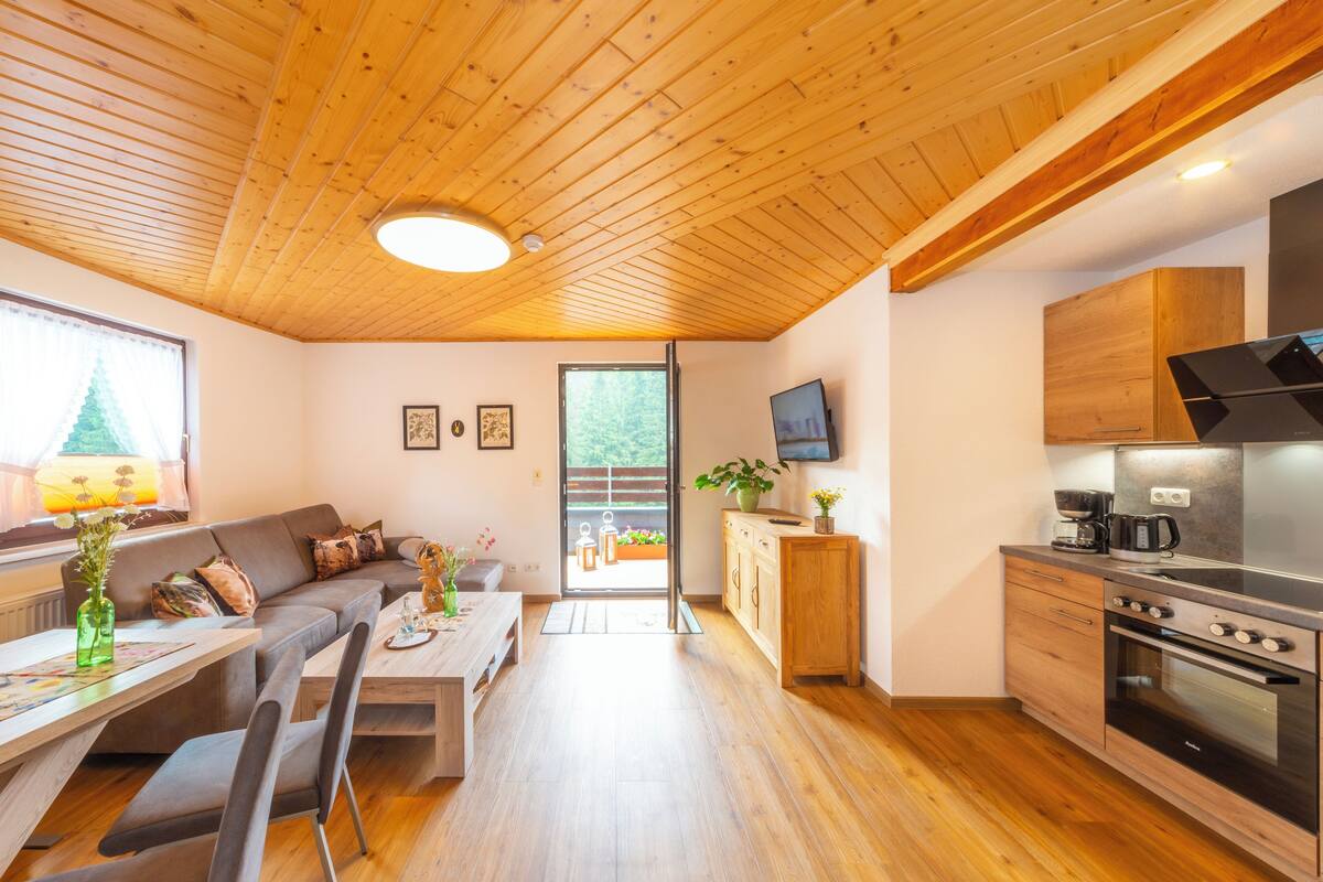 A modern kitchen with wooden cabinets and a built-in oven.