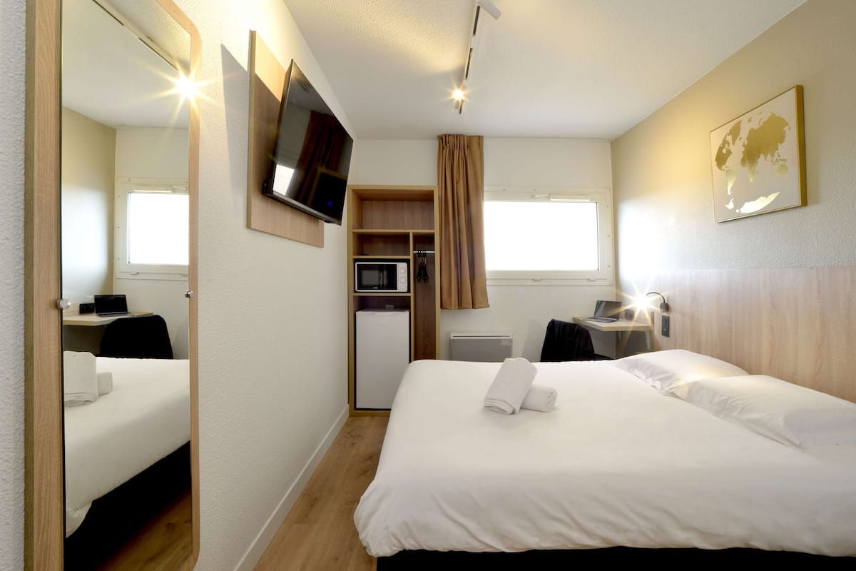 Desk, iron/ironing board, bed sheets