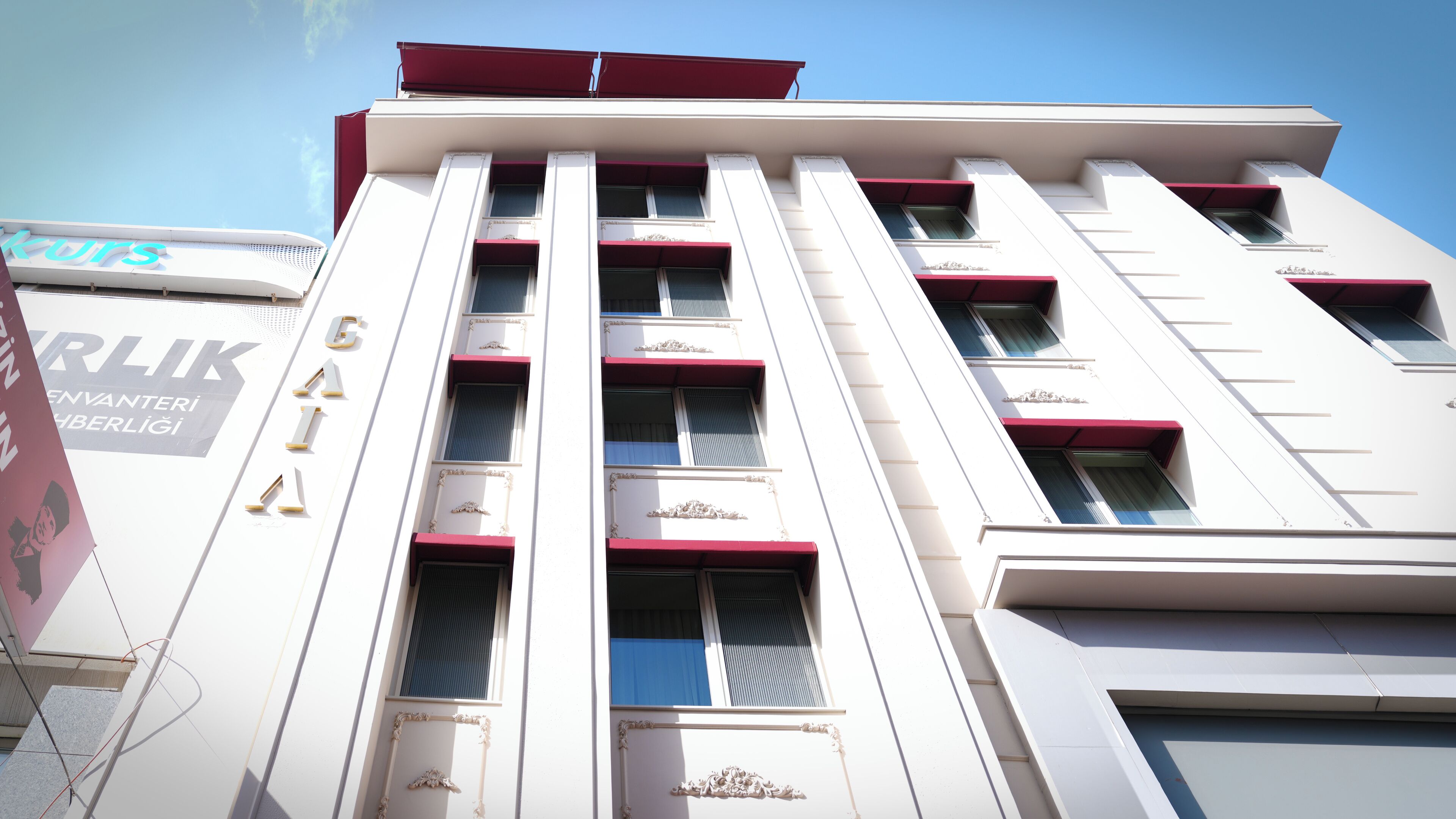 A multi-story building with a modern architectural design, featuring a series of balconies and large windows.