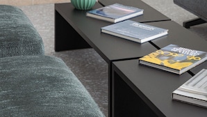 A modern living room with a black coffee table, two books, a green vase, and a fireplace. - Acropolis Iconic Estate (Athens)