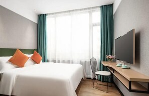 A hotel room with a bed, a desk, a chair, a television, and a window with curtains. - Puyue Hotel - Shenzhen East Railway Station Buji Metro Station (Shenzhen)
