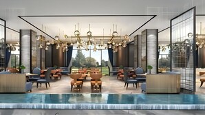 A modern indoor pool area with seating and a view of the outdoors.