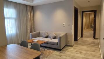 Family Apartment | Living area | 50-inch LCD TV with cable channels