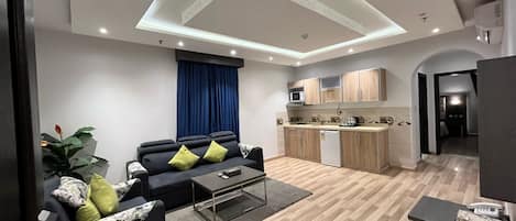 Executive Studio Suite | Living room | Flat-screen TV, streaming services