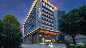 A modern hotel building with multiple floors, large windows, and a prominent entrance. - ShanShui S Hotel (Guangzhou)