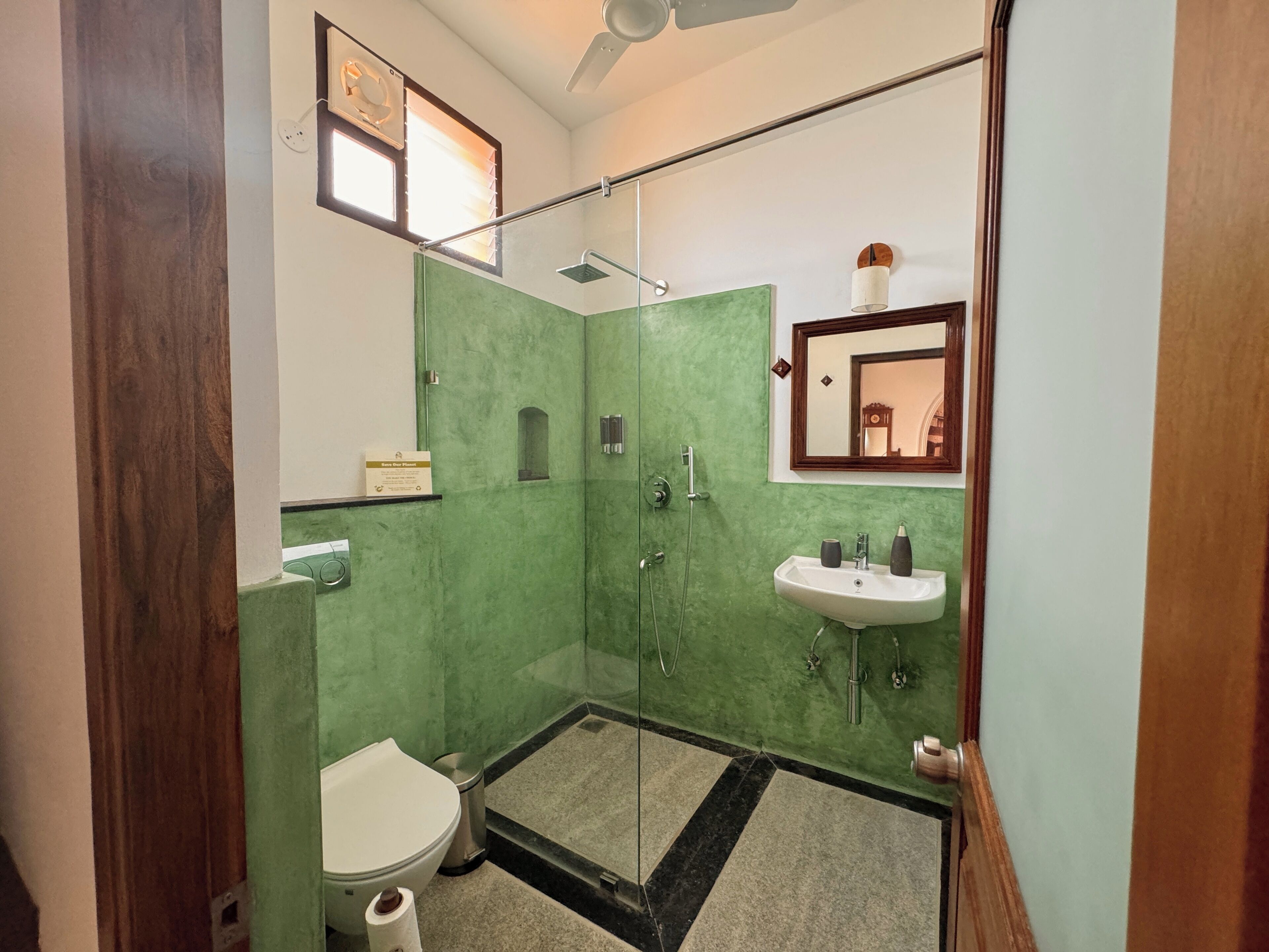 A bathroom with a toilet, sink, and shower.