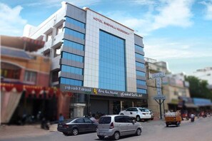 A multi-story hotel building with a modern facade, large windows, and a sign indicating it is a hotel residency. - Shri Valli Resdiency (Chennai)