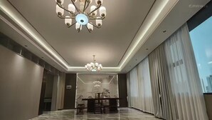 A spacious room with a marble floor, a chandelier, and a large window with curtains. - Home Inn Wanxin Ruibo Hotel  (Beihai)