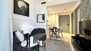 Deluxe Apartment, Balcony, City View | Living area | Flat-screen TV