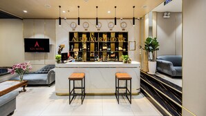 A modern A25 Hotel lobby with a bar area, seating, and a staircase. - A25 Premium Hotel - 277 Le Thanh Ton (Ho Chi Minh City)