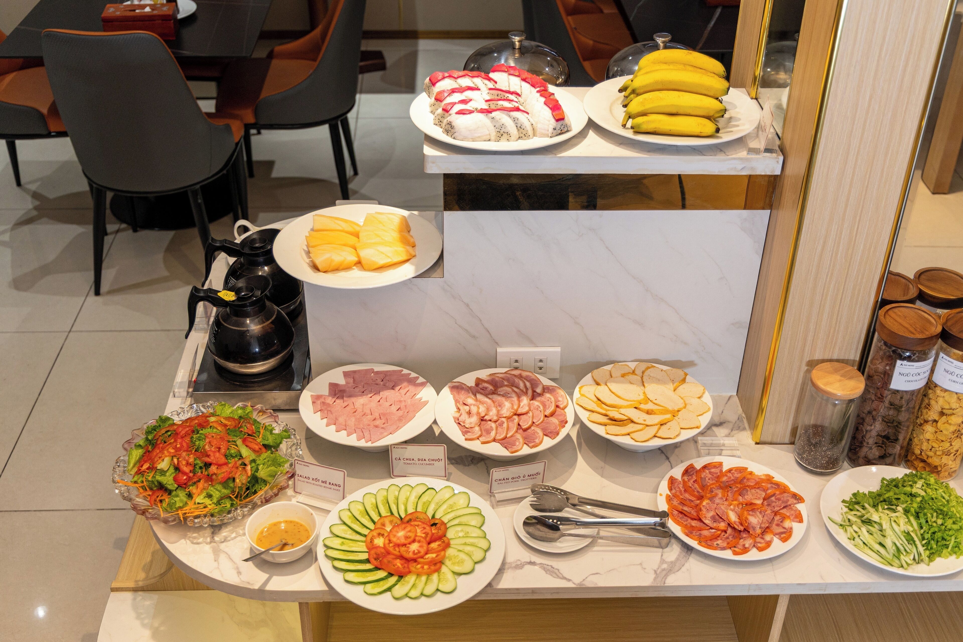 A buffet with various food items including salads, meats, and fruits.