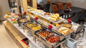 A buffet with various food items and a toaster. - A25 Premium Hotel - 277 Le Thanh Ton (Ho Chi Minh City)