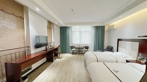 A hotel room with a bed, a desk, a TV, a chair, and a window with curtains. - Yundu Business Hotel (Xianyang)