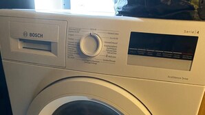 A Bosch washing machine with a control panel, a dial, and a transparent door. - TML Tomorrowland safe space with 24/7 taxi included (Mechelen)