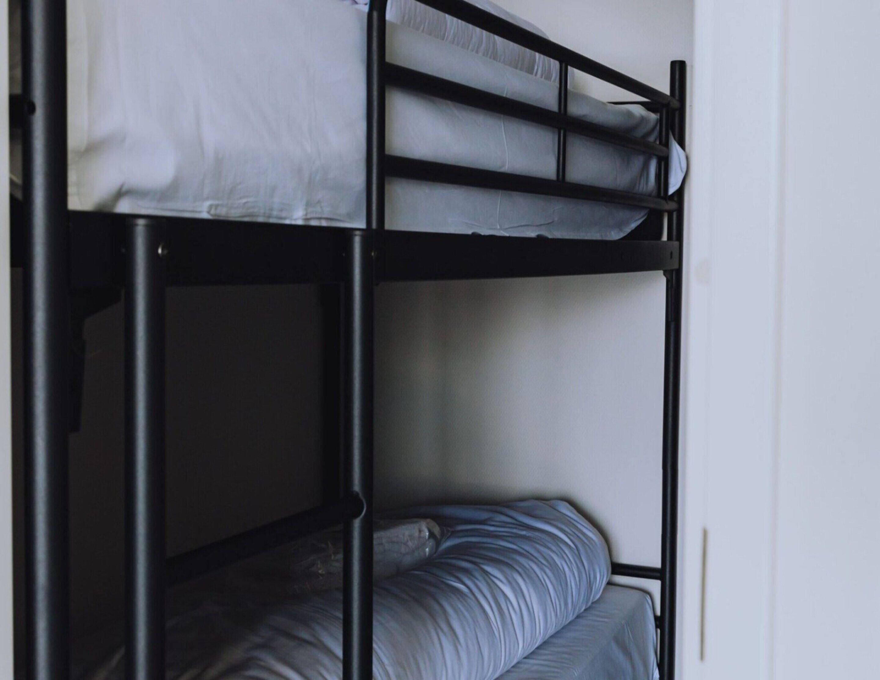 Una cama litera con colchón y almohadas.