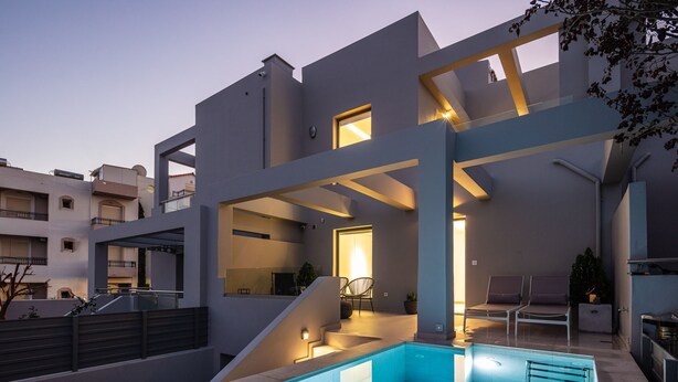 A modern multi-story building with a swimming pool, outdoor seating, and a staircase leading to the upper levels. - Akonizia Luxury House - With Private Swimming Pool (Apokoronas)