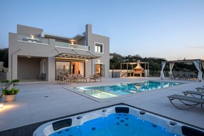 A modern house with a swimming pool, outdoor seating, and a hot tub. - Villa Atyfia - With Private Pool (Rethymno)