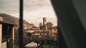 A view of a town with a prominent church tower, surrounded by residential buildings and a park area.