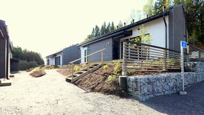 A modern building with a gravel driveway leading to a wooden staircase. - Forenom Serviced Apartments Espoo Nupuri (Espoo)
