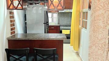 Full-size fridge, microwave, coffee grinder, cookware/dishes/utensils