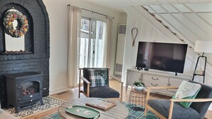 A cozy living room with a fireplace, a television, and comfortable seating.