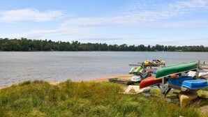 A lakeside view with boats docked on a trailer.