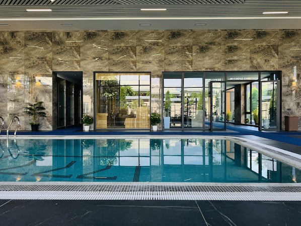 Indoor pool, seasonal outdoor pool, pool umbrellas, pool loungers