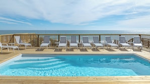 A wooden deck with a pool and lounge chairs facing a beach. - Paradise #169 - Mini-Resort, Private Pool & Hot Tub, Sleeps 38 (North Topsail Beach)