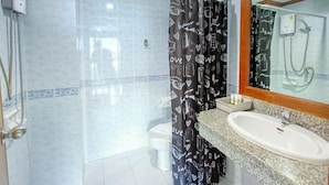A bathroom with a shower, toilet, and sink. - Phuket suite hotel  (Patong)