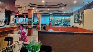 A restaurant with a bar area, wooden decor, and a ceiling with recessed lighting. - Phuket suite hotel  (Patong)