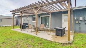 A covered patio with a wooden pergola, outdoor seating, and a grill. - 6 Mi to Beaches! Seminole Home w/ Furnished Patio (Seminole)
